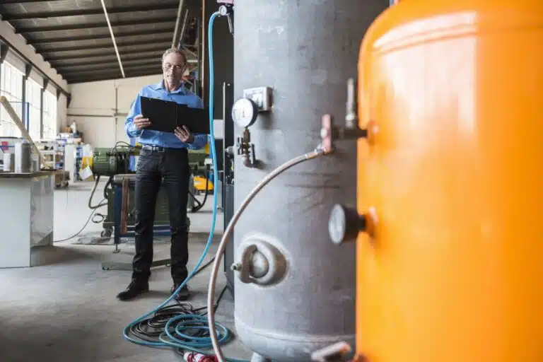 KO-MET Industrietechnik - Prüfungen & Sicherheit 6 man-with-clipboard-on-factory-shop-floor-2024-09-15-02-58-23-utc